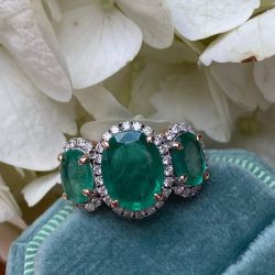 Two Tone Three Stone Halo Oval Cut Emerald Engagement Ring