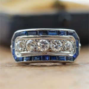 Vintage Halo Blue & White Sapphire Round & Baguette Cut Engagement Ring