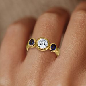 Bezel Round & Oval Cut White & Blue Sapphire Three Stone Engagement Ring