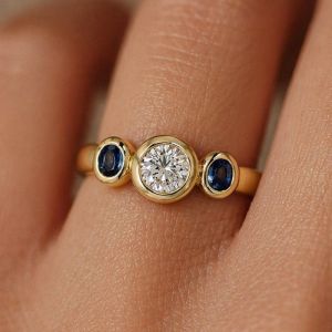 Bezel Round & Oval Cut White & Blue Sapphire Three Stone Engagement Ring