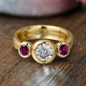 Golden Bezel Round & Oval Cut White & Ruby Sapphire Three Stone Engagement Ring 