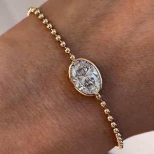 Golden Bezel Solitaire Oval Cut White Sapphire Tennis Bracelet