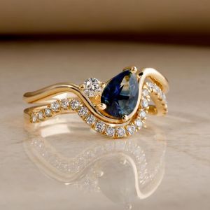 Golden Twist Pear & Round Cut Blue & White Sapphire Engagement Ring Sets